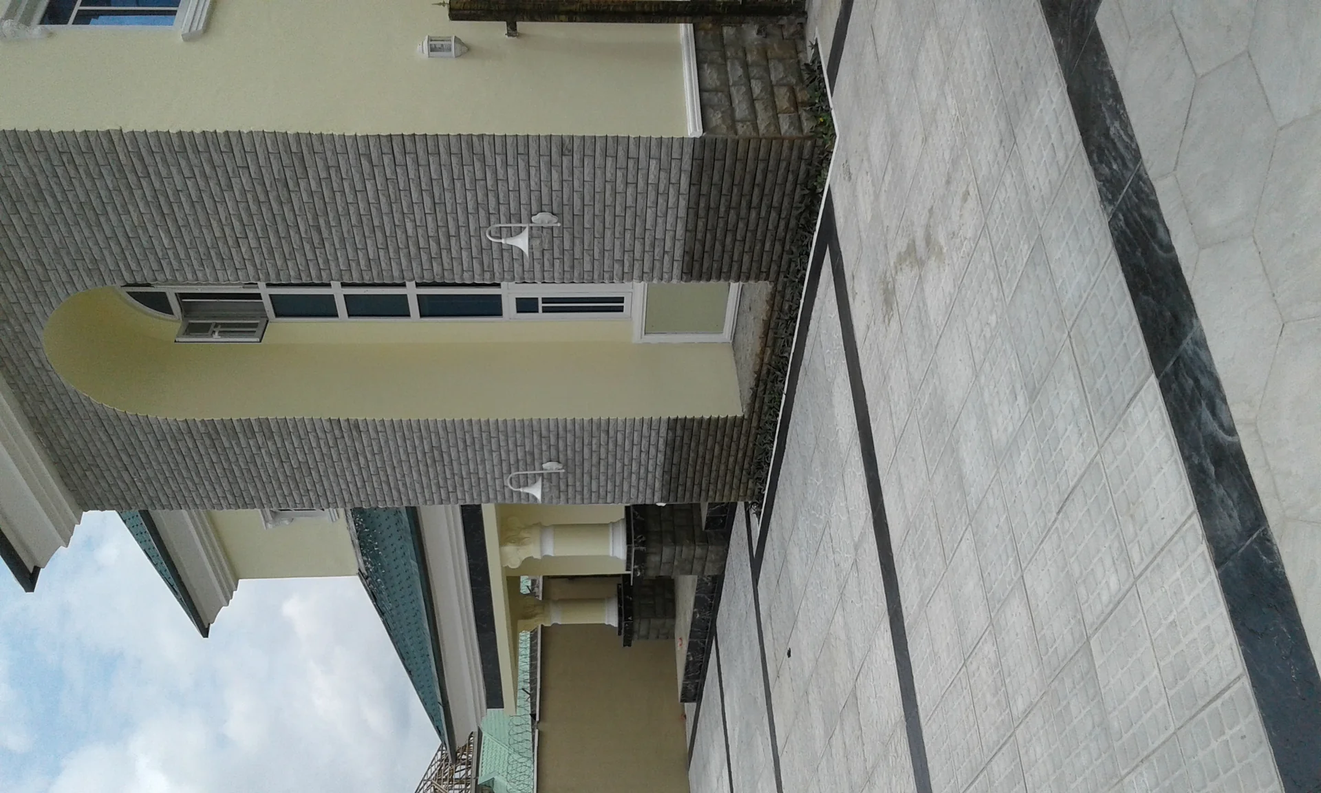 Paved driveway and stone patio installed with concrete pavers